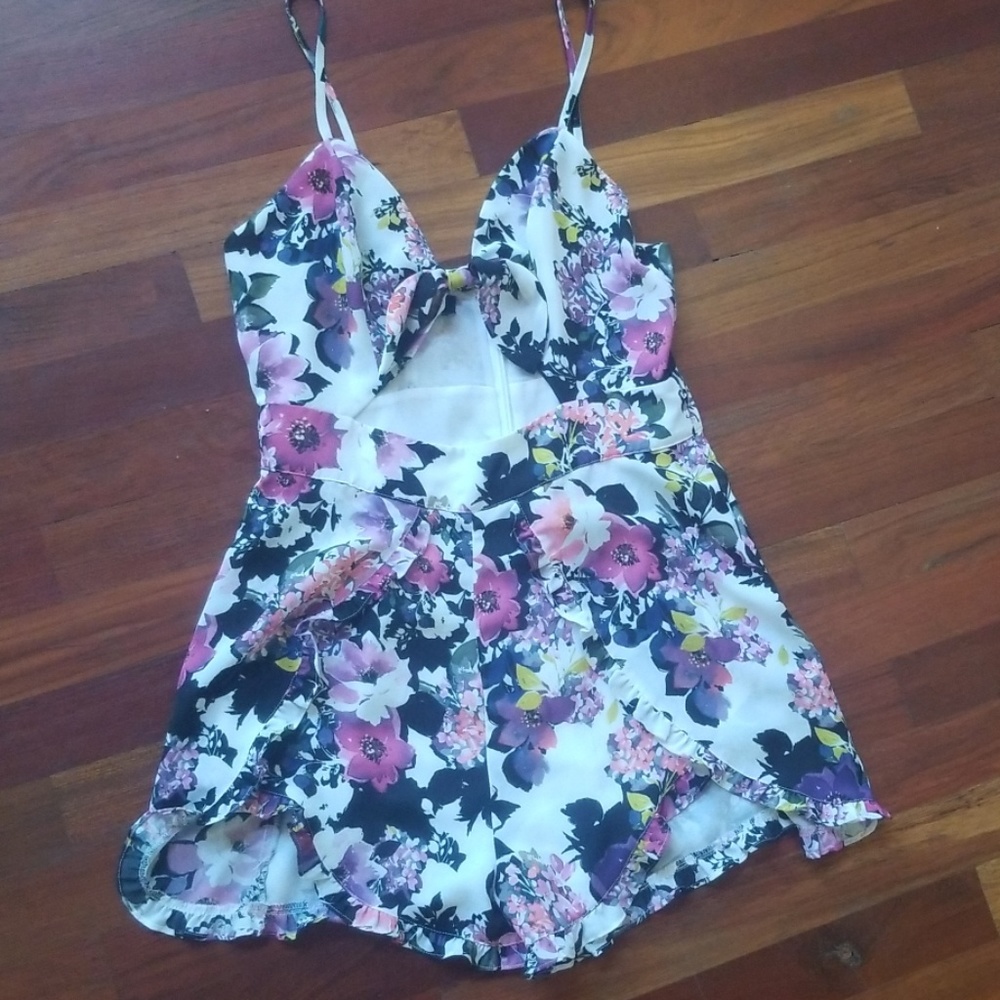 Bebe floral ruffle hem romper cutout